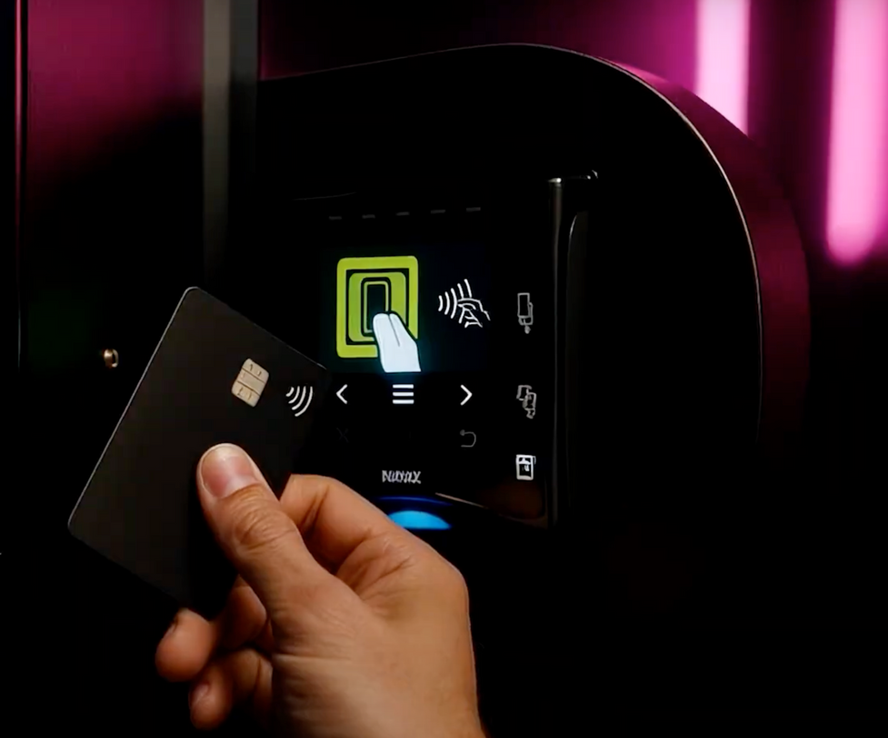 A contactless card being used at a vending machine payment terminal.